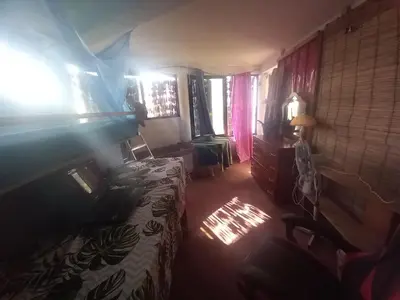 a bedroom with a bed and a window with sunlight at Casa Fabrice in Ribeira da Prata