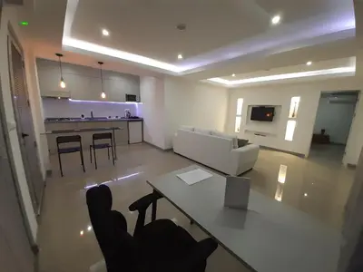 a living room with a white couch and a table at Apto T1 Sweet Home in Praia