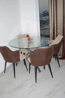 a glass dining table with two chairs and a glass table at AG TOUR LDA - Apartamentos Turísticos in Praia