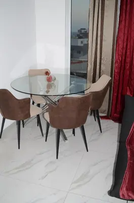 a glass dining table with two chairs and a glass table at AG TOUR LDA - Apartamentos Turísticos in Praia