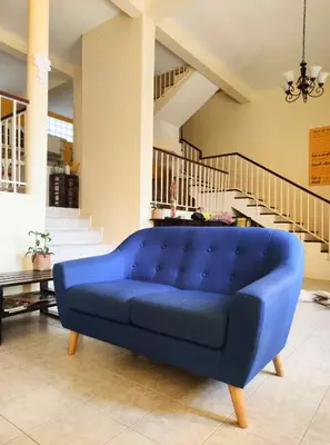 a blue couch in a living room with stairs at Casa Bom Dia in Mindelo