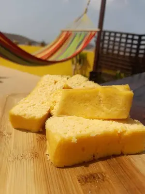 two slices of bread on a wooden cutting board at Casa Bom Dia in Mindelo