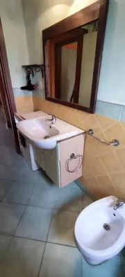 a bathroom with a sink and a toilet and a mirror at Sal Service djasal residence with pool in Santa Maria