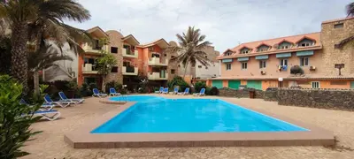 a swimming pool in front of a building at Sal Service djasal residence with pool in Santa Maria