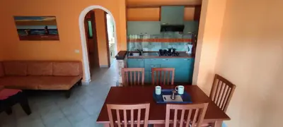 a kitchen and dining room with a table and chairs at Sal Service djasal residence with pool in Santa Maria