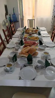 a long table with plates of food on it at LAFAYETTE Alojamentos in Espargos