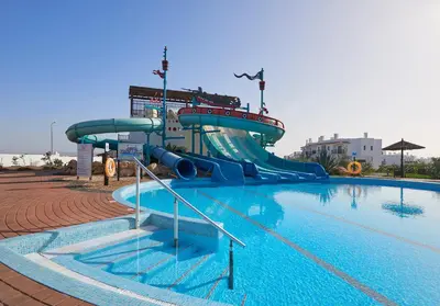 a water slide in a swimming pool at Melia Dunas Beach Resort & Spa - All Inclusive in Santa Maria