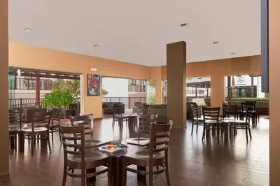 a dining room with tables and chairs and windows at Melia Dunas Beach Resort & Spa - All Inclusive in Santa Maria