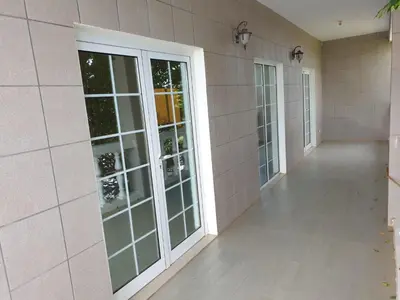 a hallway with glass doors in a building at Cactus Guest House in Cidade Velha