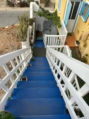 a staircase leading up to a house with blue stairs at B&B Mi Ma Bo, Sal Rei, Boa Vista, Cape Verde, FREE WI-FI in Sal Rei
