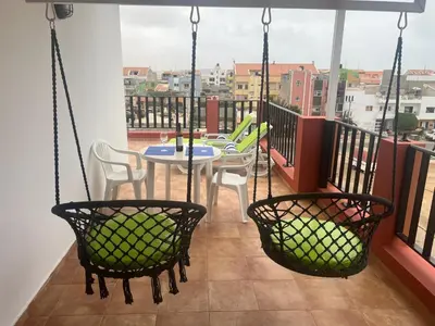 a patio with a table and chairs on a balcony at FRANMAY APARTMENTS - 7 modern apartments near the beach & city in Santa Maria