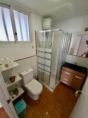 a bathroom with a toilet and a glass shower at FRANMAY APARTMENTS - 7 modern apartments near the beach & city in Santa Maria