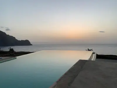 a swimming pool with the ocean in the background at Palmeira Da Cruz EcoLodge in Chã da Igreja
