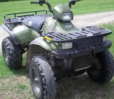 a green four wheeler parked on the side of a road at Residensia Ka Denxu in Vila Nova Sintra