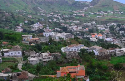a village on a hill with houses and mountains at Residensia Ka Denxu in Vila Nova Sintra