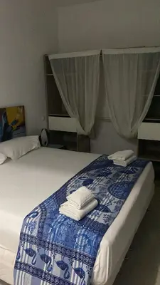 a bedroom with a bed with two towels on it at Maison Residencial casa de ferias in Pedra Badejo