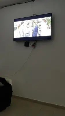a flat screen tv hanging on a wall at Maison Residencial casa de ferias in Pedra Badejo