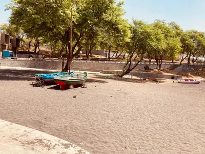 a group of boats sitting on a sandy beach at Pedra de Rala in Porto Novo