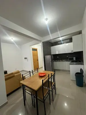 a kitchen and dining room with a table and chairs at Apartamento Novo, Brand New Apartament T1, Cidadela, Praia, Cabo Verde in Praia