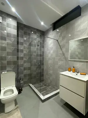 a bathroom with a shower and a toilet and a sink at Apartamento Novo, Brand New Apartament T1, Cidadela, Praia, Cabo Verde in Praia