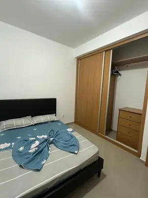 a bedroom with a bed with a blue robe on it at Apartamento Novo, Brand New Apartament T1, Cidadela, Praia, Cabo Verde in Praia