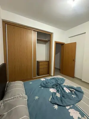 a bedroom with a bed with a blue comforter at Apartamento Novo, Brand New Apartament T1, Cidadela, Praia, Cabo Verde in Praia