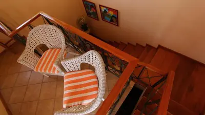 an overhead view of a staircase with chairs with an orange and white pillow at Kira's Boutique Hotel in Mindelo