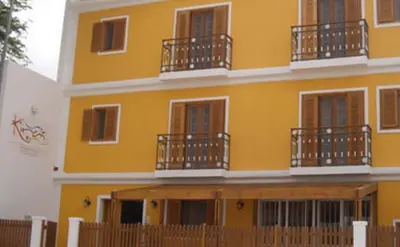 a yellow building with balconies on the side of it at Kira's Boutique Hotel in Mindelo