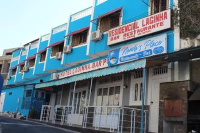 a blue building with signs on the side of it at Residencial Laginha in Mindelo