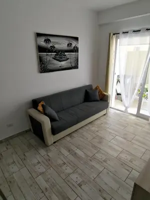 a living room with a couch and a window at Rosa dei Venti Apartment 50meter beach front in Sal Rei