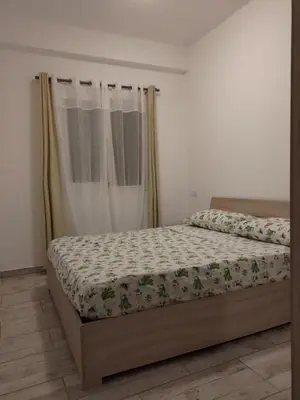 a bedroom with a bed with a comforter on it at Rosa dei Venti Apartment 50meter beach front in Sal Rei
