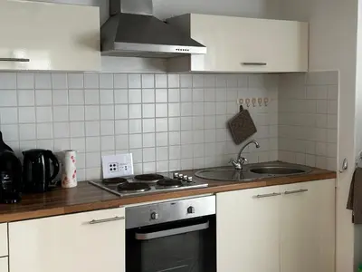 a kitchen with a sink and a stove top oven at Leme Bedje - By Bobbywashere in Santa Maria