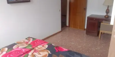 a room with a bed with roses on it at Cubico Tota in Praia