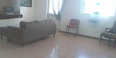 a living room with a couch and two chairs at Cubico Tota in Praia