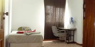 a bedroom with a bed and a table and a chair at Cubico Tota in Praia
