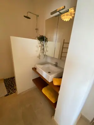 a bathroom with a sink and a mirror at Villa Nº 25 Alfredo Marchetti Suites on the Beach,Praia de Chaves BV in Cabeçadas