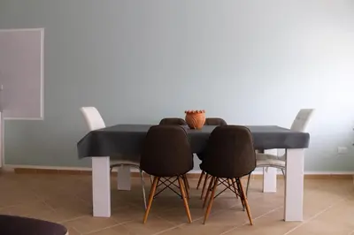 a dining room table with chairs and a black table at African Sunset in Sal Rei