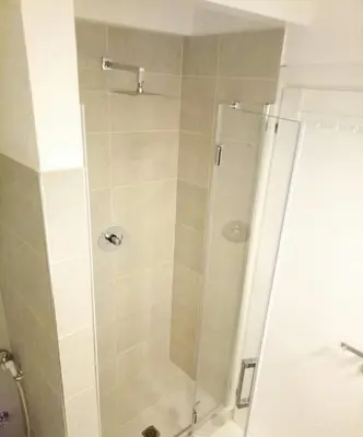 a shower with a glass door in a bathroom at App Rosanna, Estoril Beach, 2steps from the sea, Free Wi-Fi & AC in Sal Rei