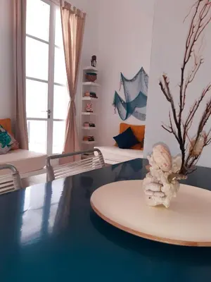 a room with a surfboard on a table at App Rosanna, Estoril Beach, 2steps from the sea, Free Wi-Fi & AC in Sal Rei
