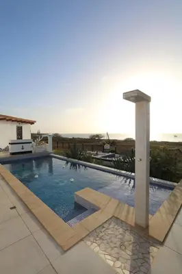 a swimming pool in the middle of a house at L' Ancora - Room With Exclusive Pool And Terrace in Palmeira