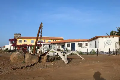 a pile of logs and rocks in front of a house at L' Ancora - Room With Exclusive Pool And Terrace in Palmeira