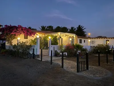 a house with lights in front of it at night at L' Ancora - Room With Exclusive Pool And Terrace in Palmeira