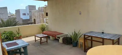 a patio with a bench and tables on a balcony at Ka-Bela 2 in Sal Rei