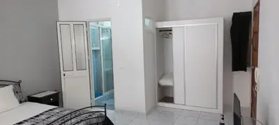 a white bedroom with a bed and a mirror at Ka-Bela 2 in Sal Rei