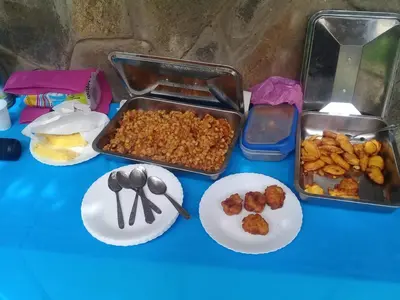 a blue table topped with plates of food and spoons at Hotel São Jorge village in Órgãos