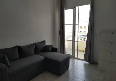 a living room with a couch and a large window at Ca'Claudia Boavista in Sal Rei