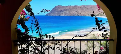 a view of a beach from a window at Rose`s place in Mindelo
