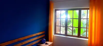 a blue room with a bench and a window at Rose`s place in Mindelo