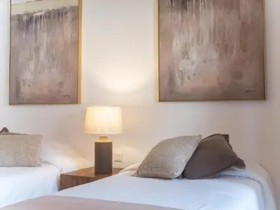 a bedroom with two beds and a lamp at Casa da Djedja in Mindelo