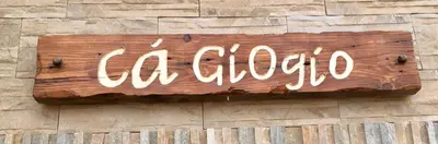 a wooden sign on the side of a building at Ca GIOgió in Santa Maria